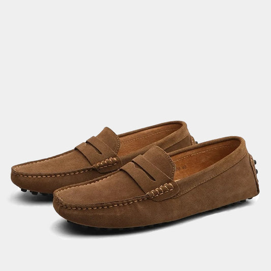 Pair of men's slip-on loafers with moc toe stitching and penny strap detail