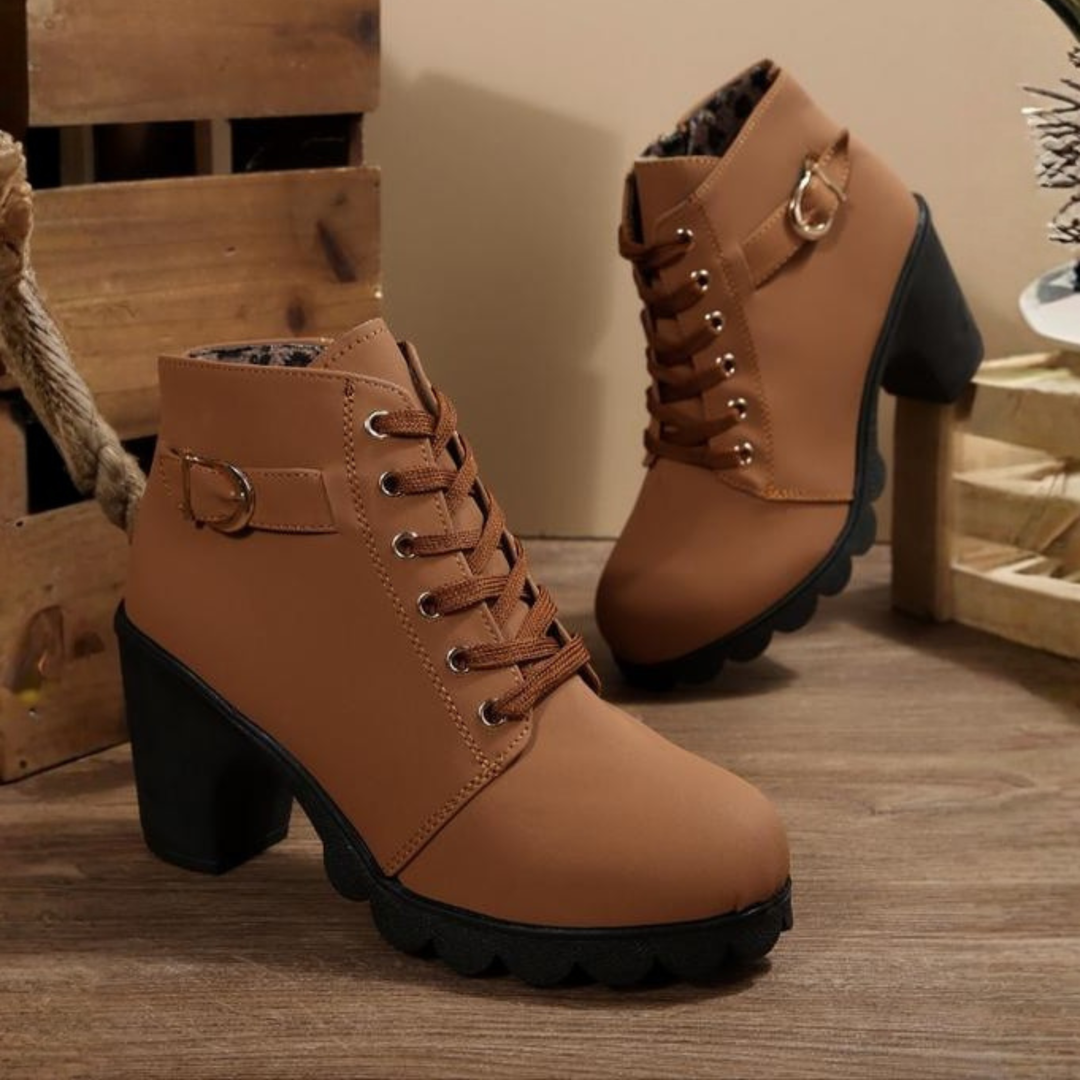 Women's black lace-up ankle boots with metal buckle detail and chunky sole