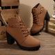 Women's black lace-up ankle boots with metal buckle detail and chunky sole