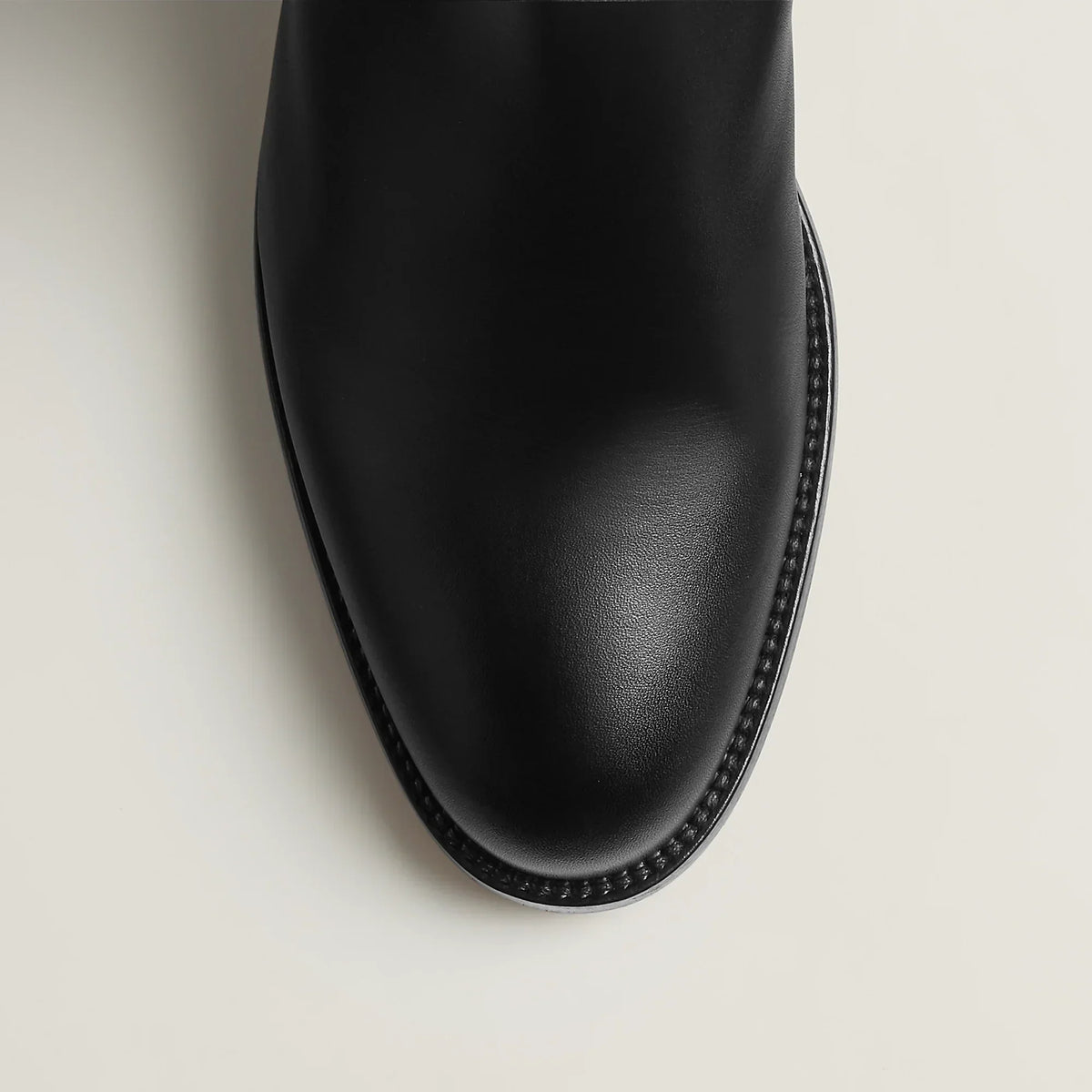 Women's tall riding boots with round toes, low heels and upper strap detail