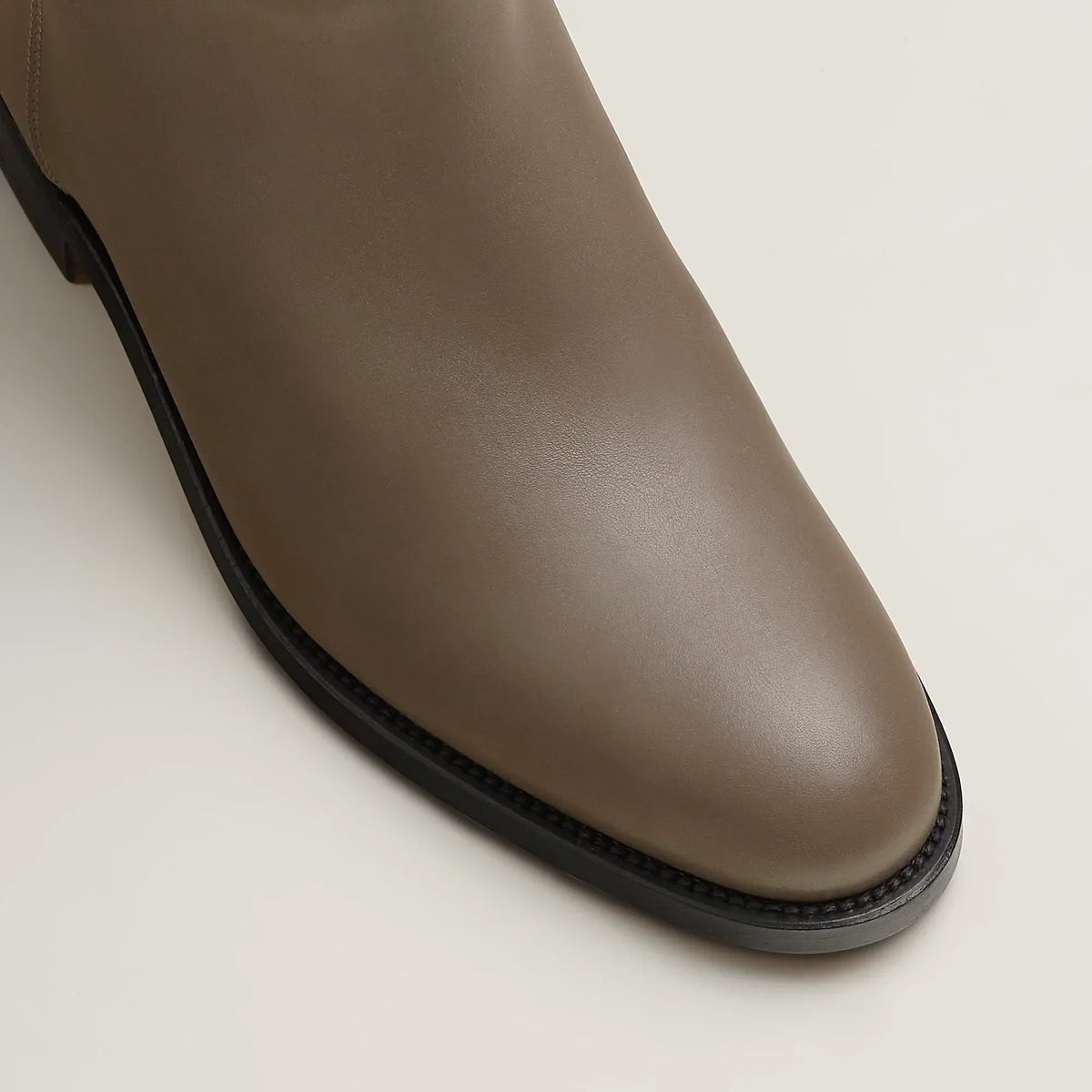 Women's tall riding boots with round toes, low heels and upper strap detail