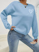 Women's crew neck sweatshirt with long sleeves and heart chest graphic