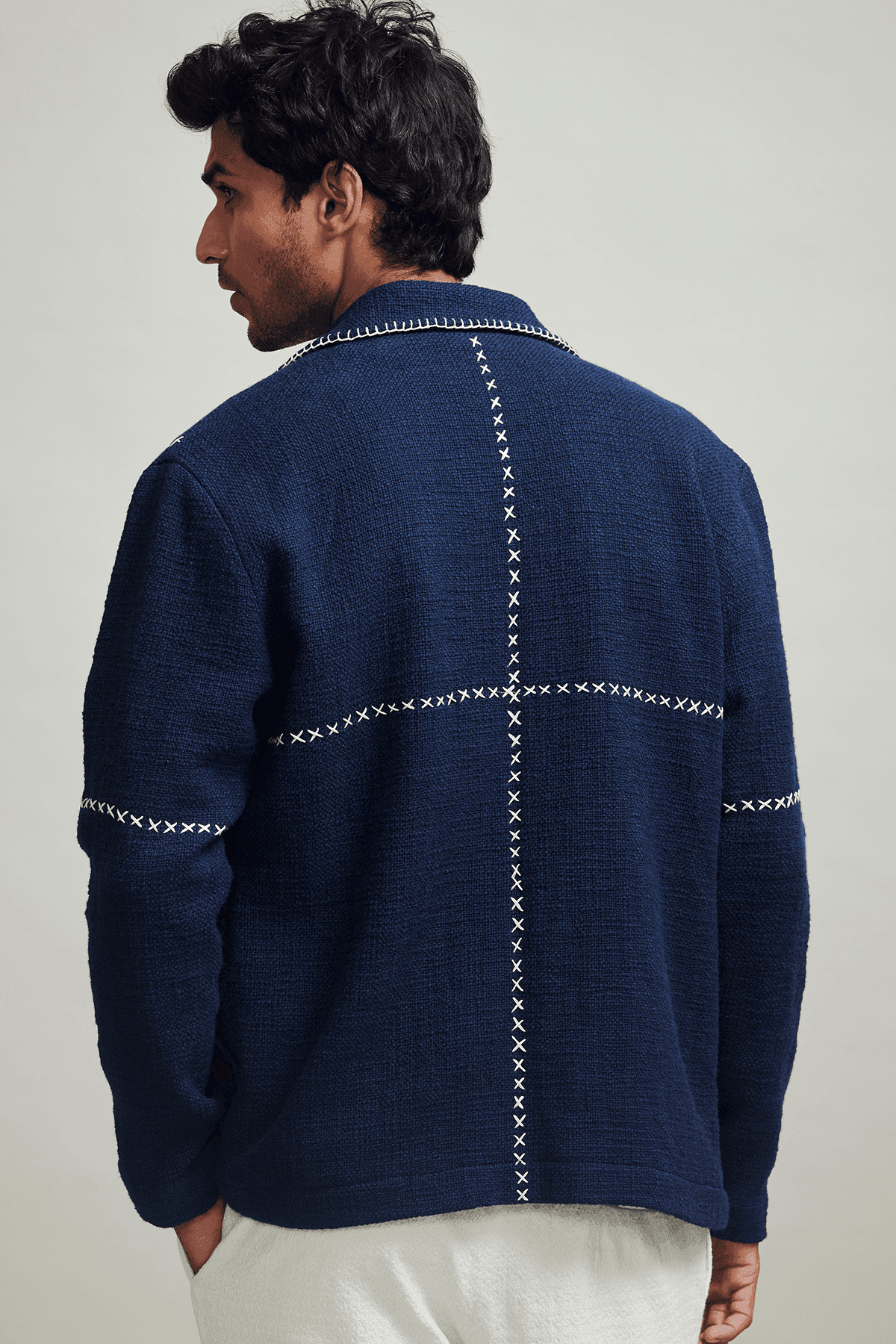 Men's navy zip jacket with stand collar and contrasting cross-stitch detailing