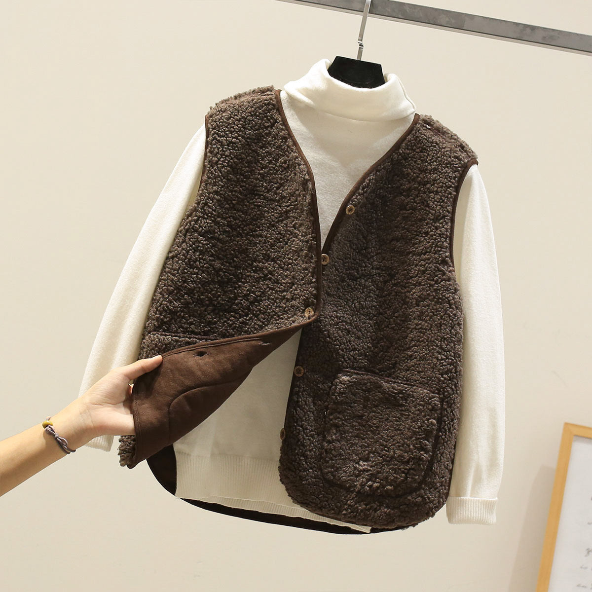 Women's textured sleeveless vest with button front and large patch pockets