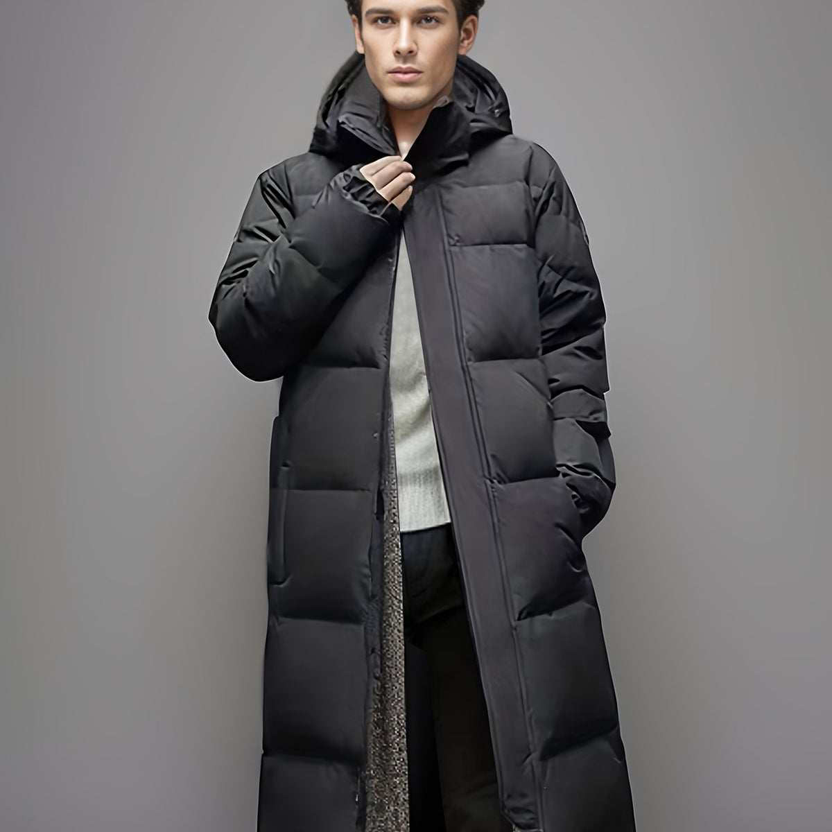 Men's black long hooded puffer coat with quilted panels and zip front
