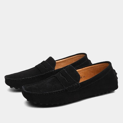 Pair of men's slip-on loafers with moc toe stitching and penny strap detail