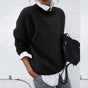 Women's relaxed crew neck sweater with long sleeves layered over a collared shirt