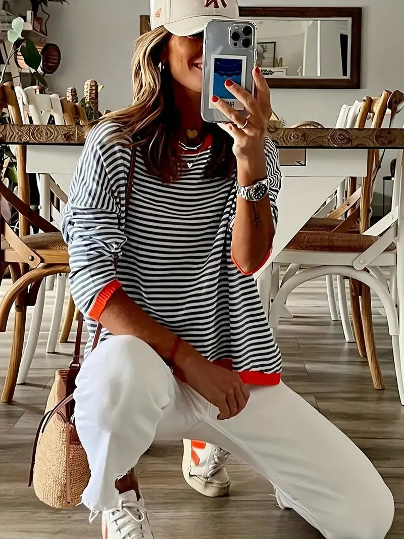 Women's black and white striped jumper with orange ribbed trim