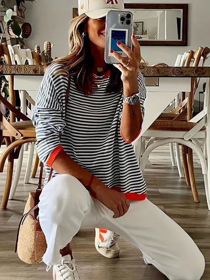 Women's black and white striped jumper with orange ribbed trim