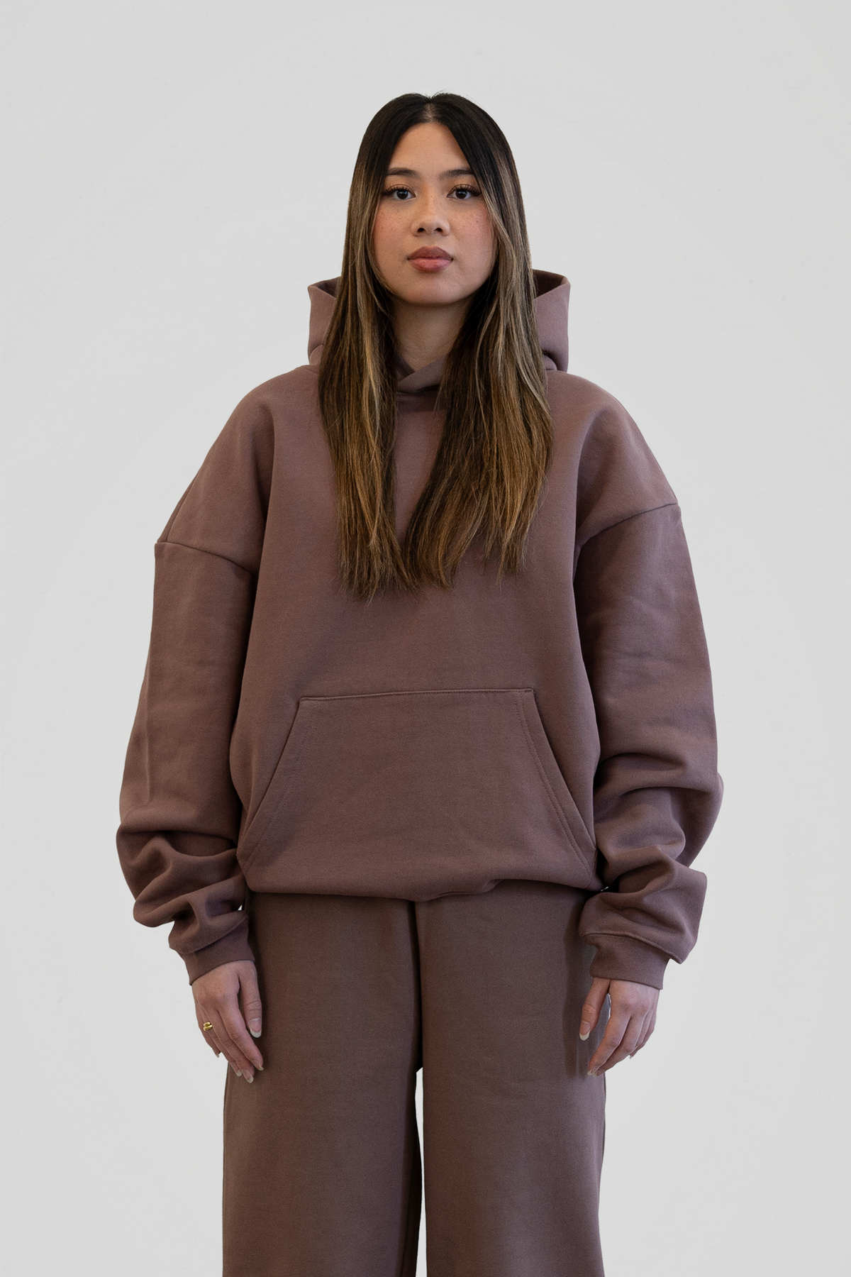 Women's brown hooded sweatshirt with long sleeves and front kangaroo pocket