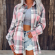 Woman wearing yellow checked long-sleeve button-up shirt, styled open over a grey crop top and distressed denim shorts