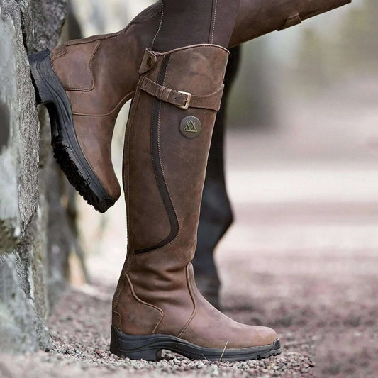 Women's tall riding boots with buckle straps, rounded toes and low heels