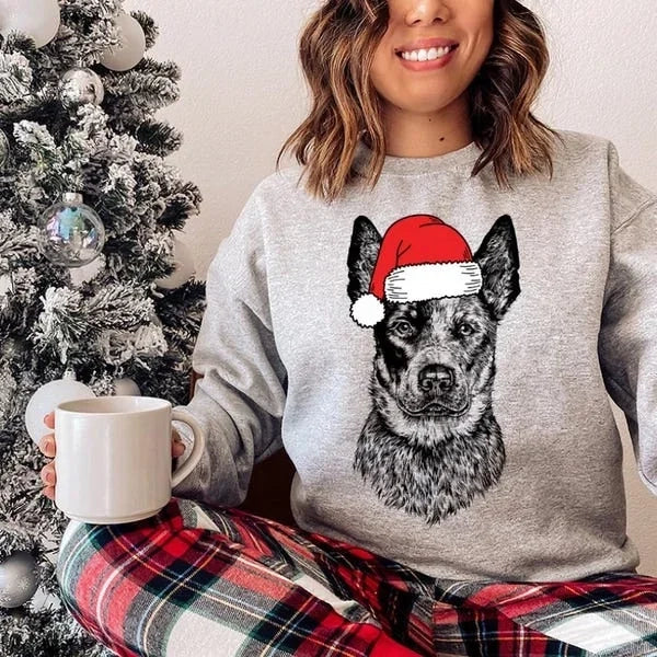 Unisex grey Christmas sweatshirt with dog Santa hat design, shown on family members around decorated kitchen
