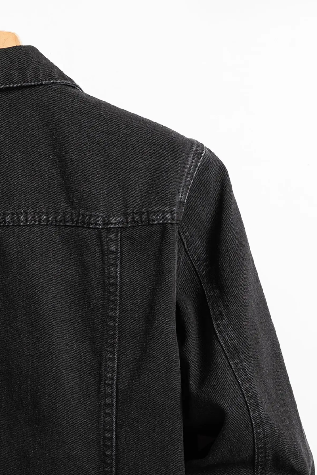 Men's black button-front denim jacket with chest flap pockets