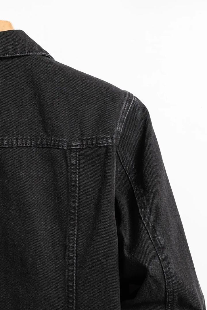 Men's black button-front denim jacket with chest flap pockets