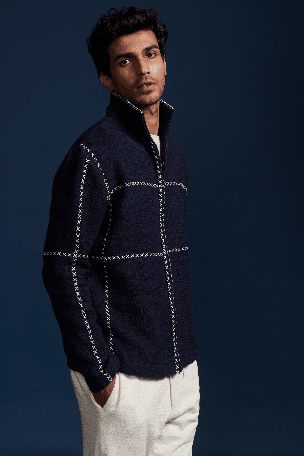 Men's navy zip jacket with stand collar and contrasting cross-stitch detailing