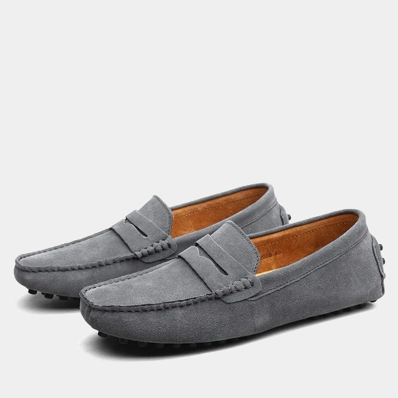 Pair of men's slip-on loafers with moc toe stitching and penny strap detail