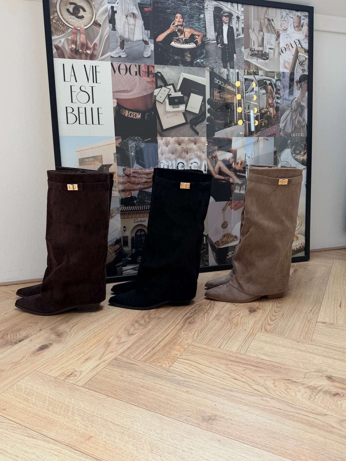 Women's brown knee-high boots with pointed toes, low heels and buckled shaft straps