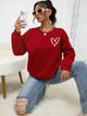 Women's crew neck sweatshirt with long sleeves and heart chest graphic