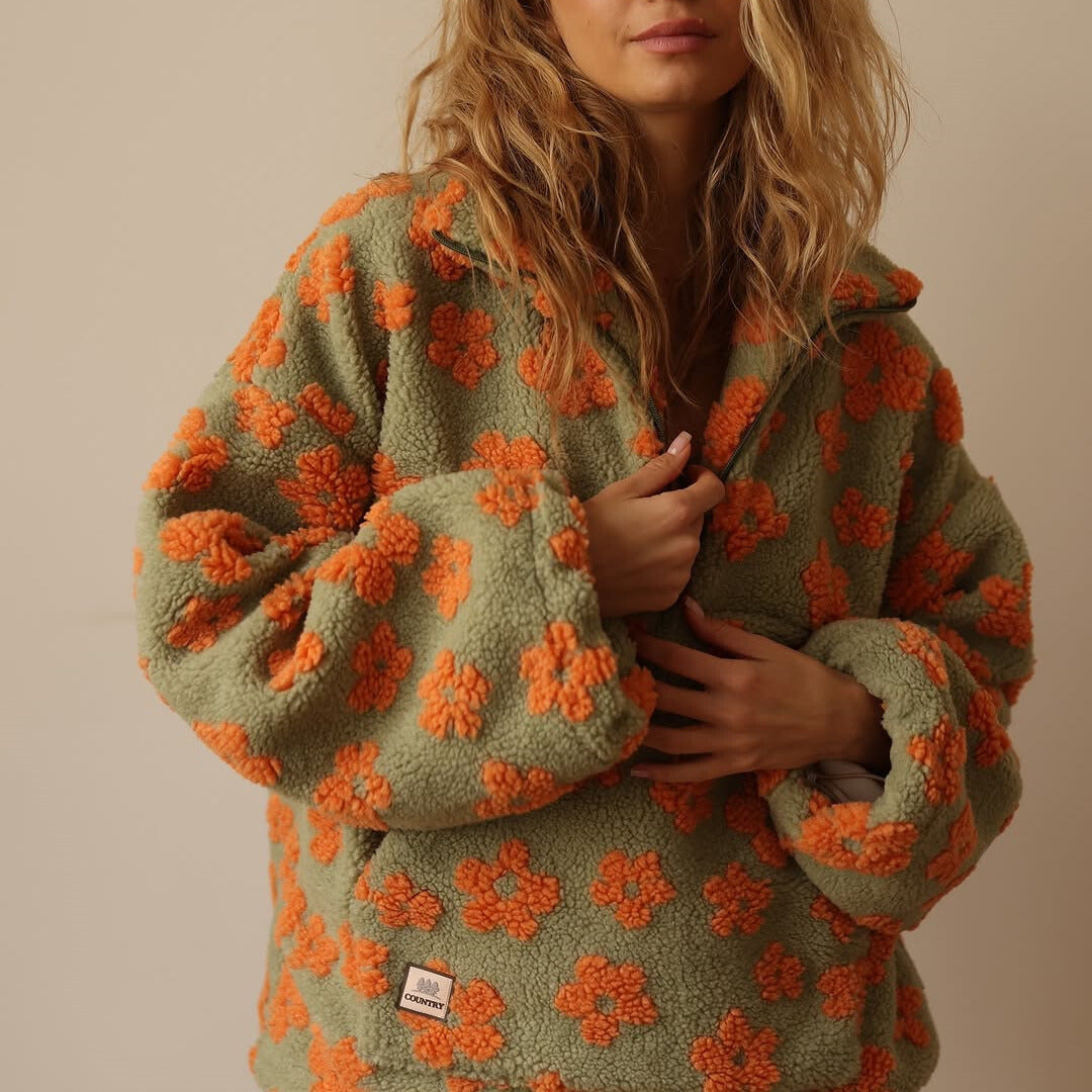 Women's floral fleece pullover with half-zip collar and front pocket