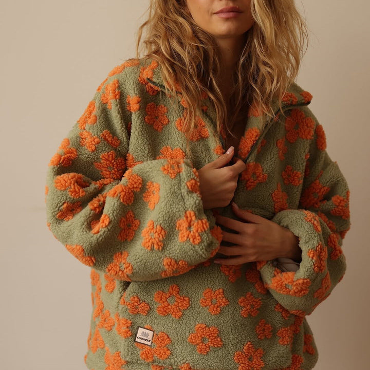 Women's floral fleece pullover with half-zip collar and front pocket