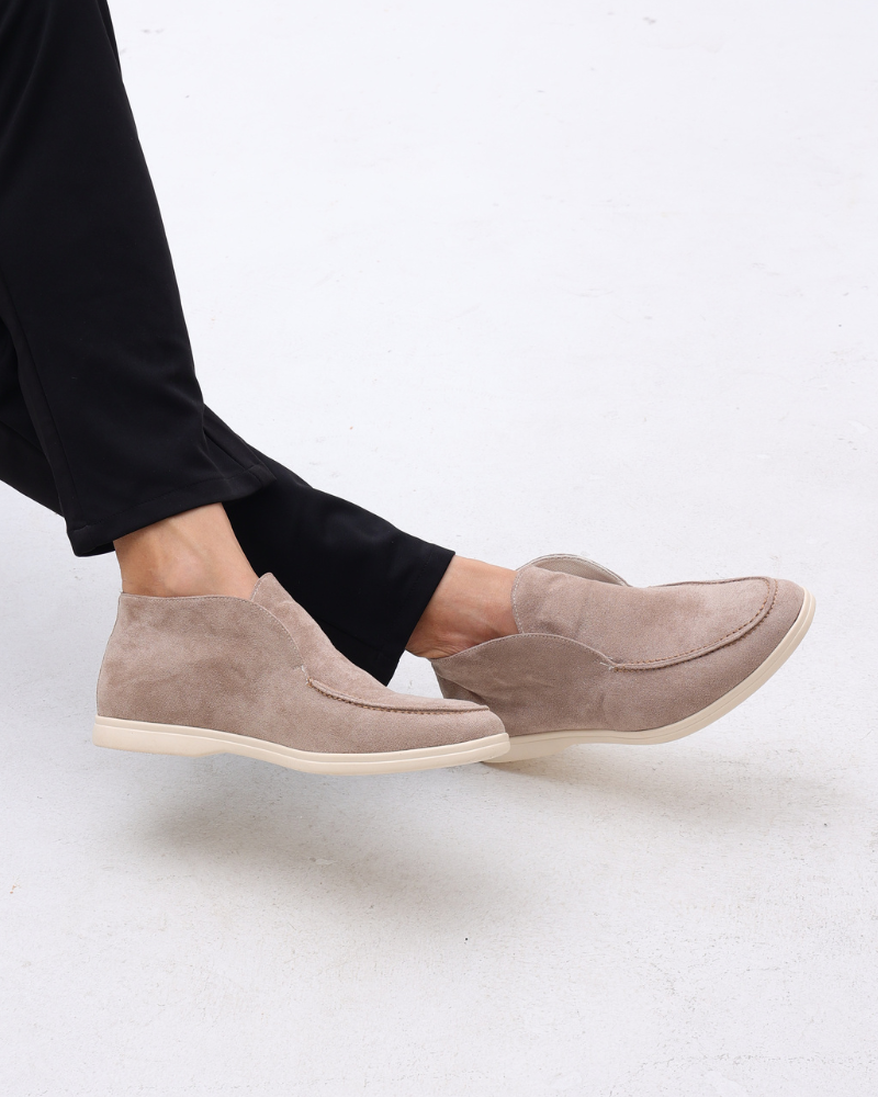 Ankle-height slip-on loafers with rounded toes, stitched apron detailing and flat contrasting soles