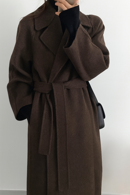 Women's long solid wrap coat with wide lapels and tie belt