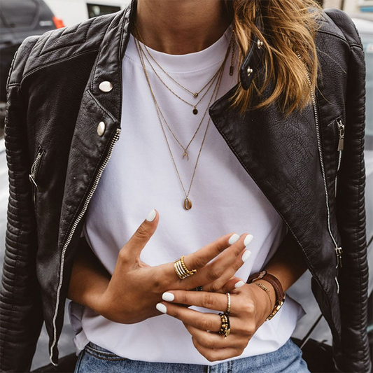 Women's black quilted cropped moto jacket with long sleeves and zip pockets