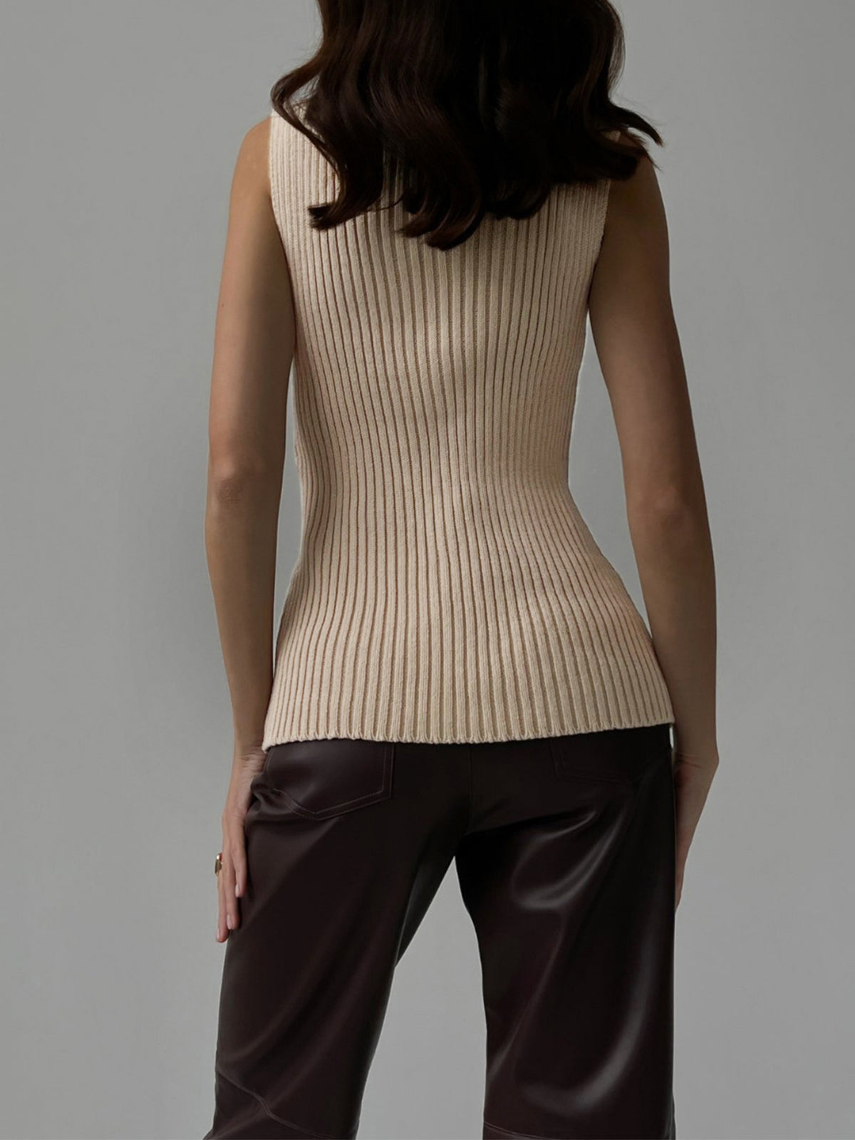 Women's ribbed sleeveless knit top with mock neckline and fitted shape