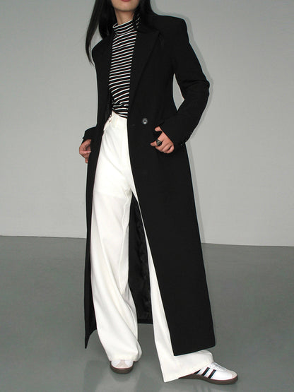 Women's long black single-breasted coat with notched lapels and front pockets