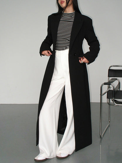 Women's long black single-breasted coat with notched lapels and front pockets