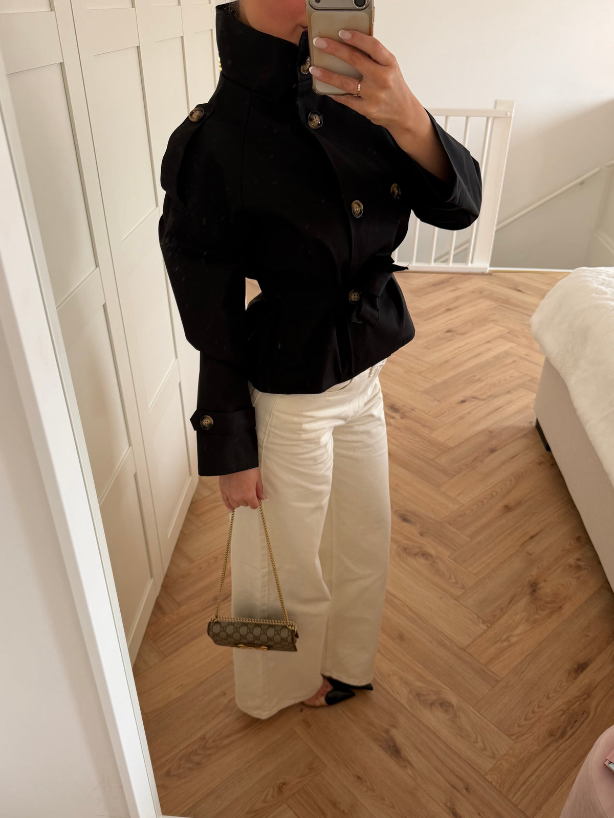 Women's black belted trench jacket with high collar and long sleeves