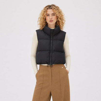 Women's cropped quilted puffer vest with high collar and zip front