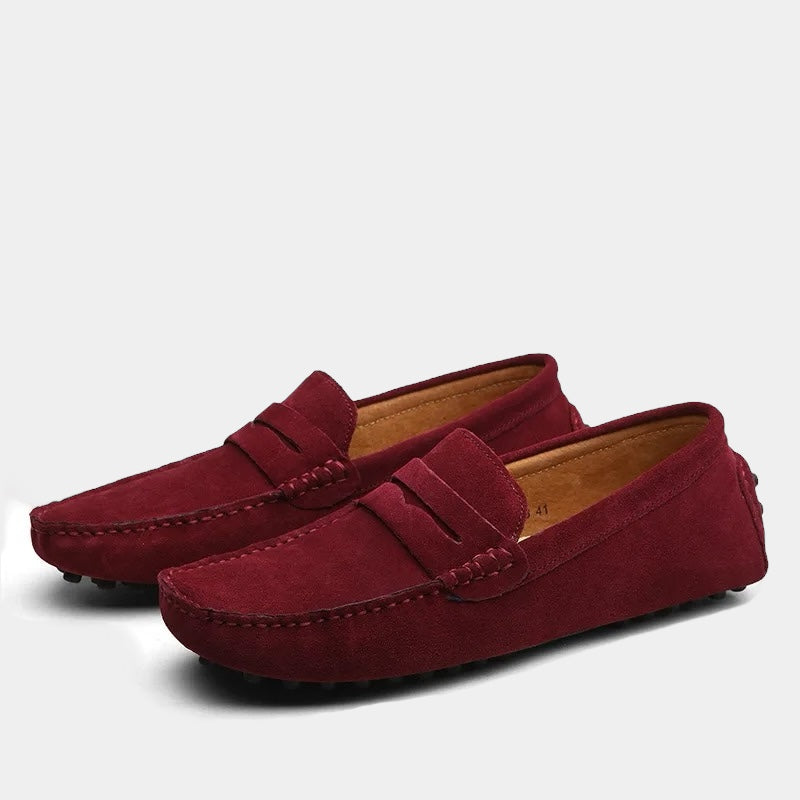 Pair of men's slip-on loafers with moc toe stitching and penny strap detail