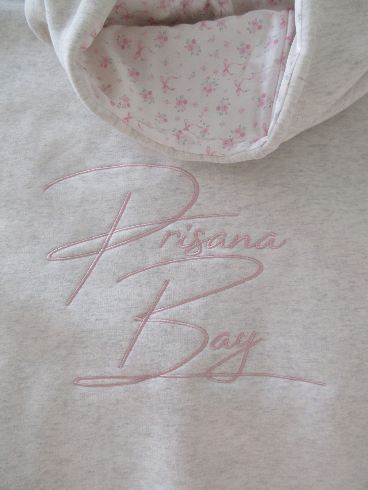 Light gray oversized hoodie with pink bow embroidery and floral hood lining