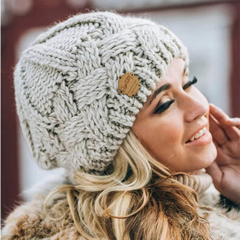 Women's chunky cable knit beanie hat with folded edge and front patch