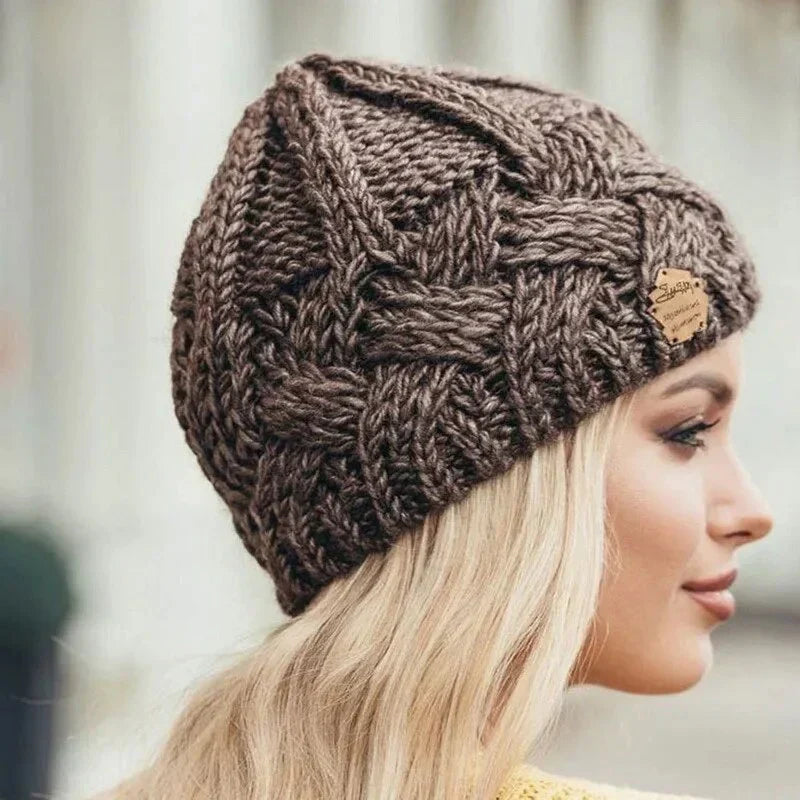 Women's chunky cable knit beanie hat with folded edge and front patch