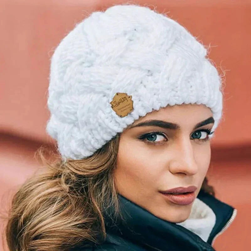 Women's chunky cable knit beanie hat with folded edge and front patch