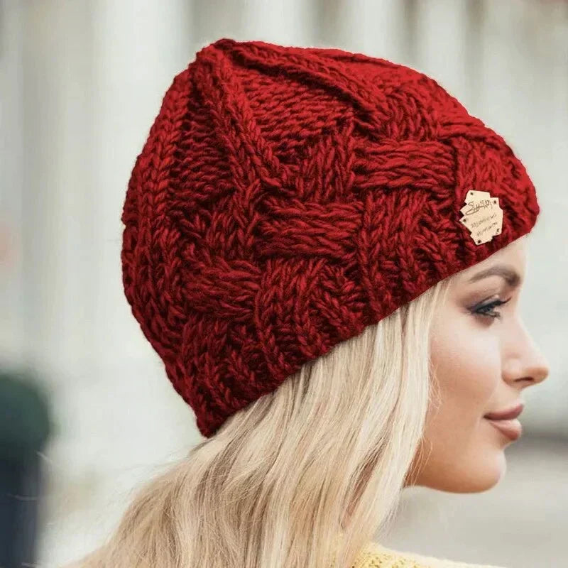 Women's chunky cable knit beanie hat with folded edge and front patch