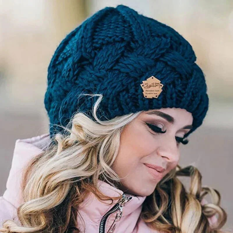 Women's chunky cable knit beanie hat with folded edge and front patch