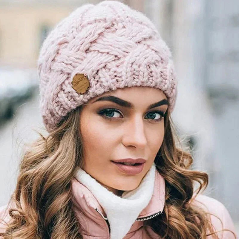 Women's chunky cable knit beanie hat with folded edge and front patch