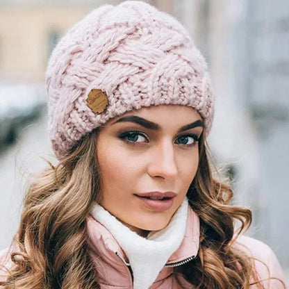 Women's chunky cable knit beanie hat with folded edge and front patch