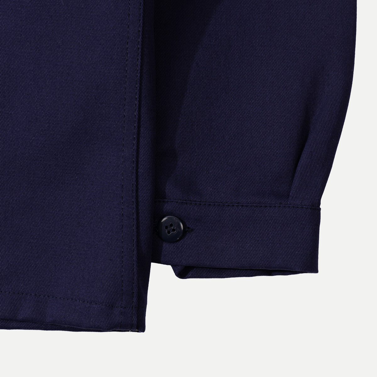 Men's navy chore jacket with button front, pointed collar and four patch pockets