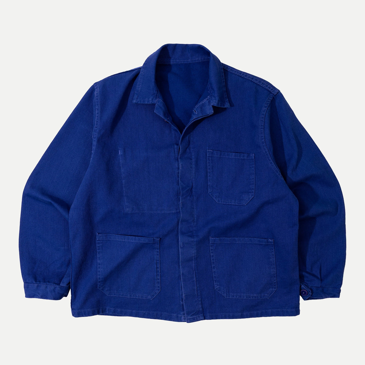 Men's blue button-front work jacket with collar and patch pockets