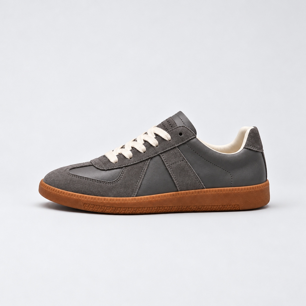 Men's low-top lace-up sneakers with textured panels and flat sole