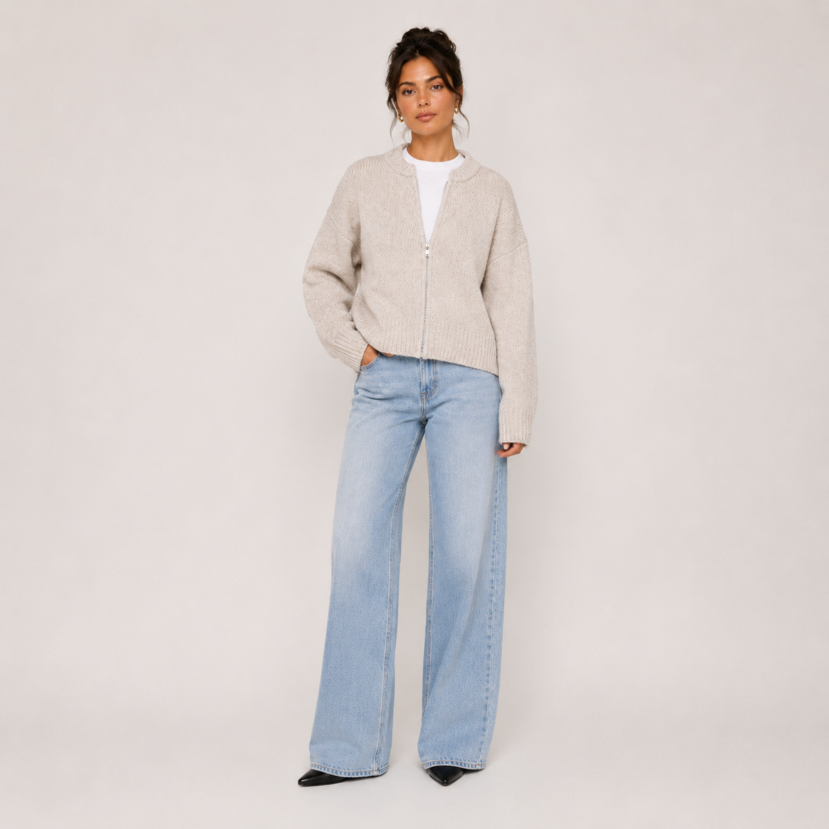 Women's beige knit jacket with crew neckline, zip front and long sleeves