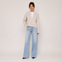 Women's beige knit jacket with crew neckline, zip front and long sleeves