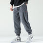 Men's textured corduroy jogger trousers with elasticated ankle cuffs