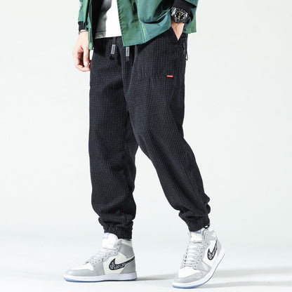 Men's textured corduroy jogger trousers with elasticated ankle cuffs
