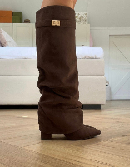 Brown women's slouch knee-high boots with pointed toes, low heels and buckle details